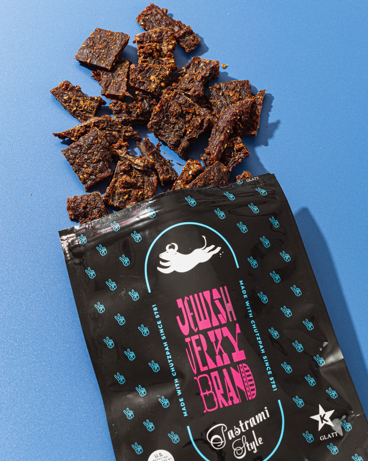 Pastrami Style bag and beef jerky on a blue background